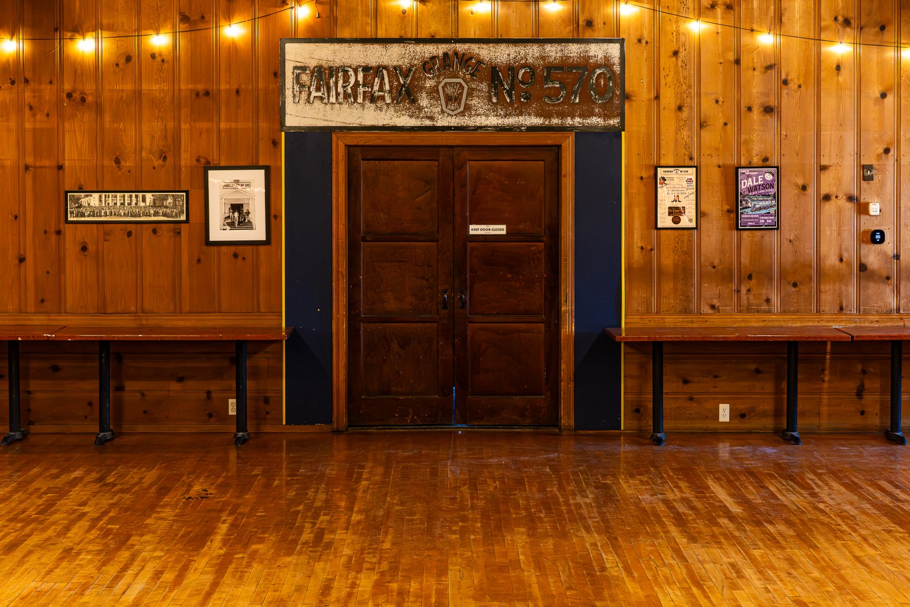 Knotty pine walls and wooden double doors in the main hall