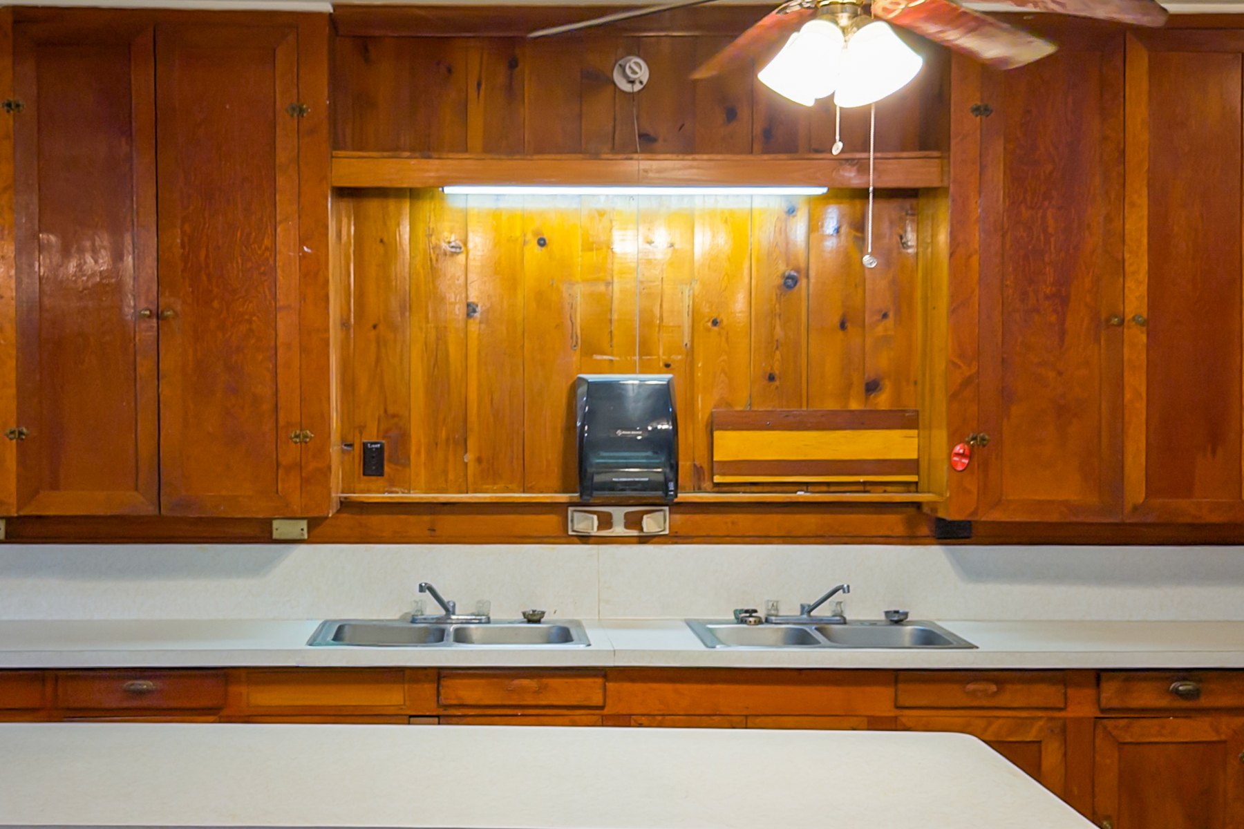 Kitchen counter with two double sinks and wood paneling