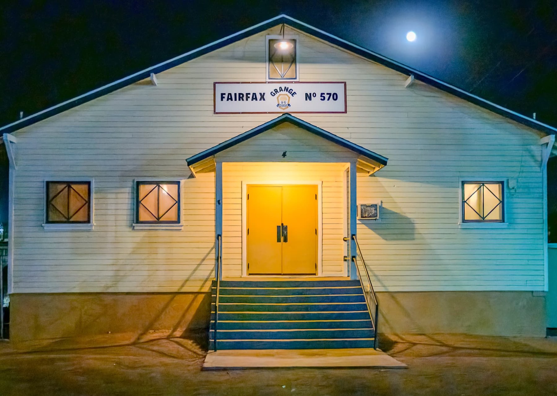 Fairfax Grange front entrance illuminated at night
