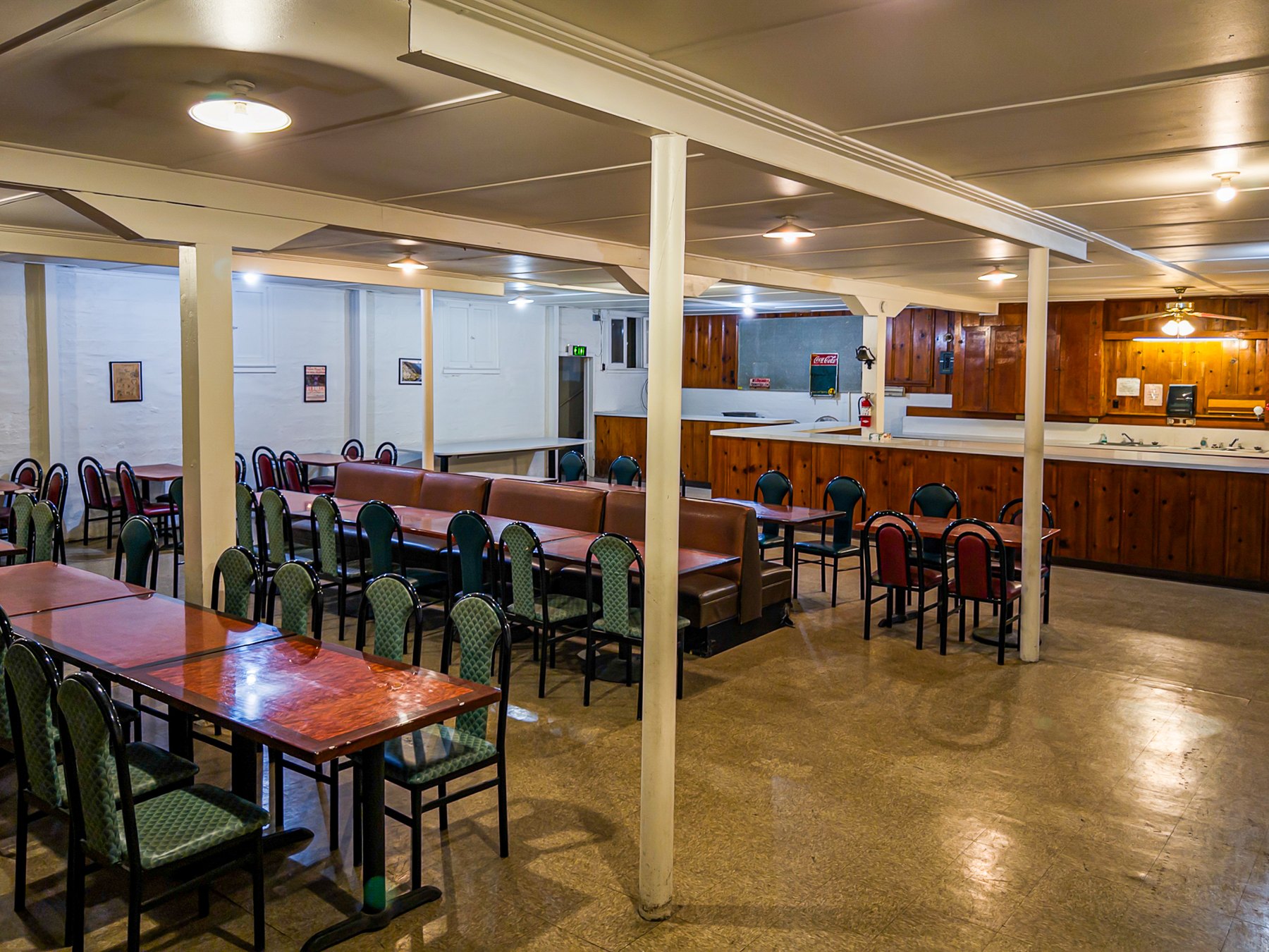 Basement dining room with tables, booth seating and support columns