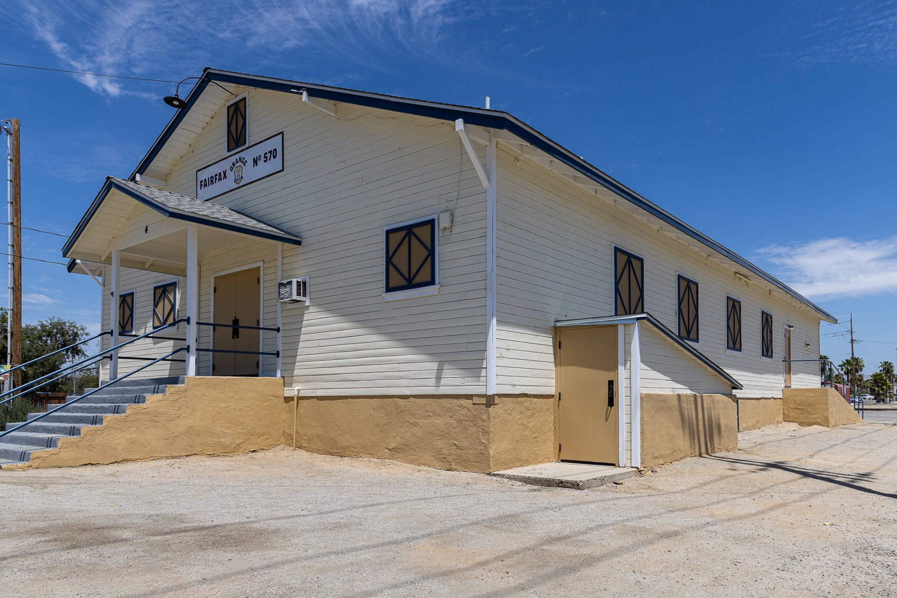 Side of Fairfax Grange with ramp entrance and adjacent parking area